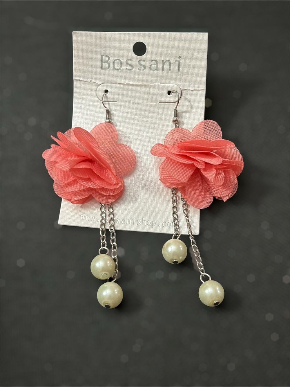 Bossani coral fabric flower drop earrings featuring dangling faux pearl accents.